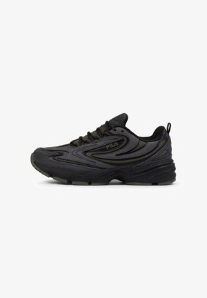 Men's black athletic shoe featuring a mix of smooth and textured materials, curved design lines, and a thick rubber sole with green accents.