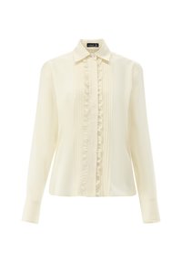 Light beige long-sleeve blouse in a smooth fabric with a button-up collar, front ruffles, and vertical pleats. Features a subtle shine.