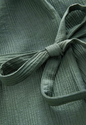 Olive green textured fabric with subtle vertical lines, featuring a tied ribbon detail. Material appears soft and lightweight.