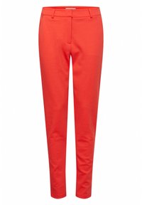 Red, fitted trousers made of a smooth fabric. Features a standard waistband, two front pockets, and a tapered leg design.