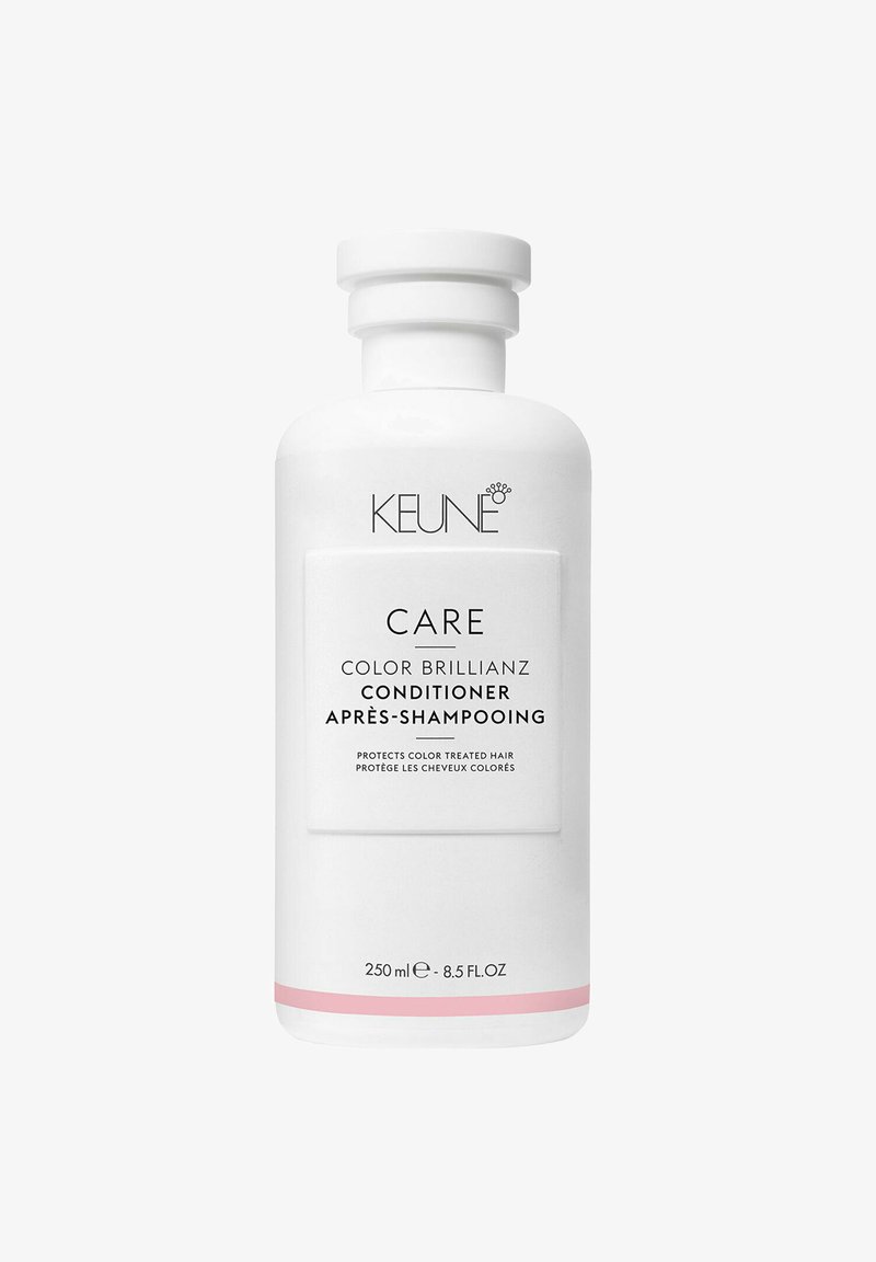 Bottiglia di balsamo in plastica bianca, dalla forma arrotondata, con un accento rosa alla base e testo nero che etichetta i dettagli del prodotto. 250 ml.