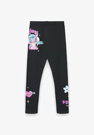 Leggings neri in misto cotone con disegni a cartoni animati. La gamba sinistra presenta un cuore rosa trafitto da una freccia; la gamba destra mostra fiori e personaggi.