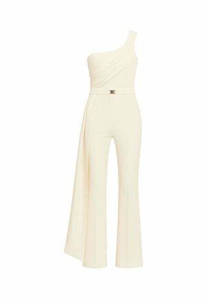 Tuta monospalla color avorio. Presenta una parte superiore drappeggiata, gambe svasate e un dettaglio in metallo dorato in vita. Realizzata in tessuto liscio.