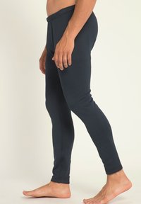 Marineblaue Leggings aus dehnbarem Stoff, mit enganliegendem Design und elastischem Bund. Sanfte Textur, minimalistische Nähte, knöchellang.