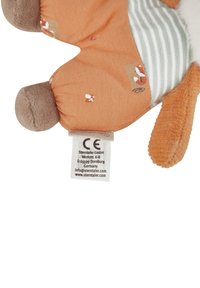 Soft plush toy with orange fabric and beige accents. Features striped pattern, textured paws, and a tag with care instructions.