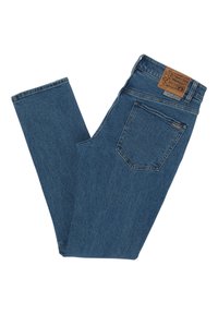 Vaqueros de mezclilla azul con un diseño de pierna recta, que presentan un parche de cuero marrón en la cintura trasera y un único bolsillo trasero.