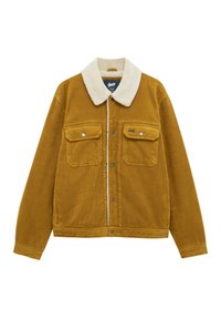 Giacca in corduroy giallo senape con colletto in finta pelliccia bianca, due tasche sul petto e chiusura con bottoni a pressione. Tessuto texture visibile.