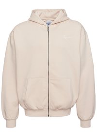Svetloružová mikina na zips s kapucňou so šnúrkou, prednými vreckami, rebrovanými manžetami a lemom a malým bielym logom na hrudi.