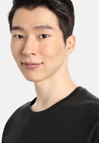 Young man with short black hair, wearing a black crew-neck t-shirt. Close-up shows light skin tone and subtle facial features.