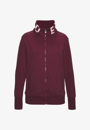 Bordeauxroter Reißverschlussjacke mit hohem Kragen und weißem Logo innen. Glatter Stoff, Seitentaschen sowie gerippte Bündchen und Saum.