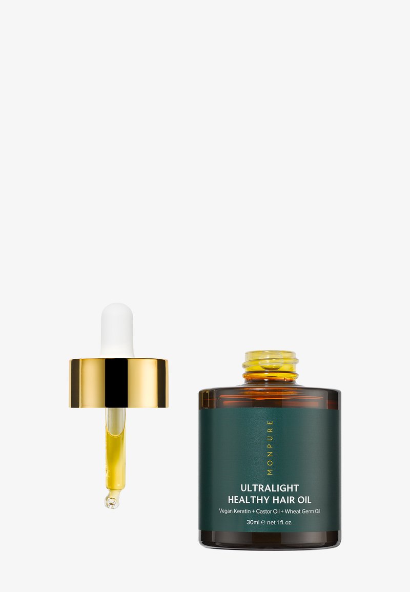 Tippa-astia, jossa on kulta-korkki ja keltainen neste, avoimen tummanvihreän pullon vieressä, jossa lukee Ultralight Healthy Hair Oil, 30 ml.