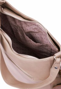 Interiér béžové kožené kabelky se zipovým uzávěrem, obsahující podšívkovou přihrádku s puntíky a další kapsu na organizaci.