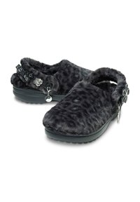 Gray plush slippers with a leopard print texture, featuring a floral accent, black straps with bows, and a thick, textured sole.