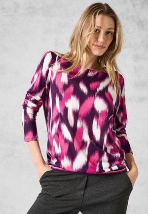 Haut à manches longues multicolore présentant un motif abstrait violet, rose et blanc. Tissu doux avec une coupe décontractée et un col rond.