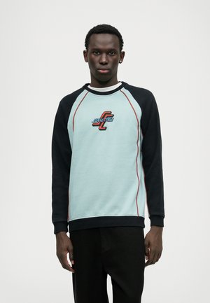 Hele helesinine dressipluus mustade raglanvarrukatega, punase aksentõmblusega ning ees on brodeeritud "Santa Cruz" logo. Sile kangastekstuuri.