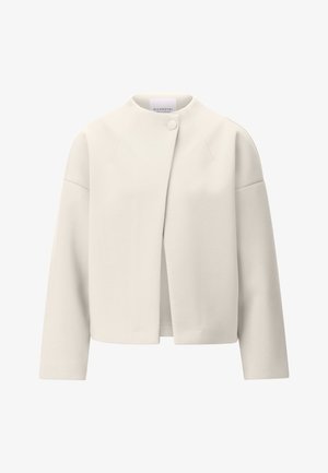 Veste couleur crème à manches longues, col rond, fermeture à un seul bouton supérieur, avec un design épuré et minimaliste.