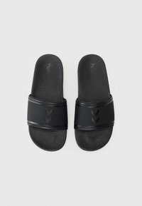 Black slide sandals made of rubber with a textured sole. Features a wide strap with embossed chevron patterns and brand logo.