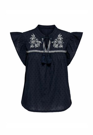 Blusa azul marino con mangas cortas acampanadas, que presenta diseños florales bordados y detalles de borlas en el escote. Tejido texturizado.