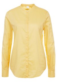 Camicia gialla a maniche lunghe con colletto alla cinese, chiusura a bottoni e texture liscia. Presenta un orlo curvo e maniche aderenti.