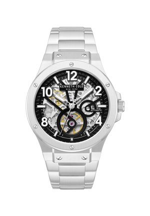 Orologio da polso automatico Kenneth Cole argento con quadrante nero e trasparente che mostra gli ingranaggi interni, indici delle ore argentati e cinturino a maglie in metallo.