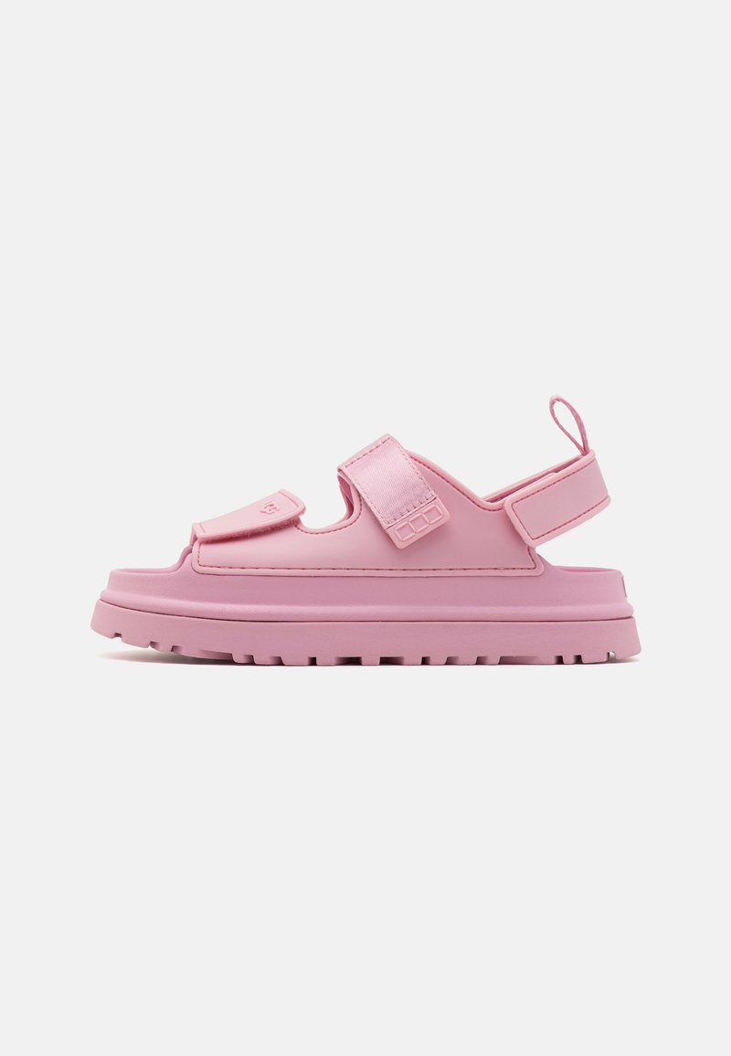 Sandal rose avec une semelle épaisse, fabriquée en matériau synthétique. Présente une bride avant avec fermeture Velcro et une bride arrière pour un ajustement sécurisé.