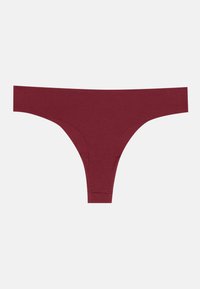 Burgundi värvi string, mis on valmistatud pehmest ja venivast kangast. Omab minimalistlikku disaini, laiad külgedega ja ilma nähtava õmbluseta. Ilma nähtava metallosata.