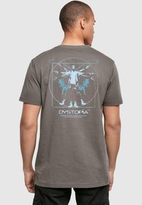 Gray cotton t-shirt featuring a blue graphic print on the back, depicting a human figure with wings and circular design elements.