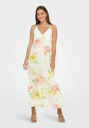 Maxi dress in lightweight fabric, featuring a floral pattern in pastel colors, V-neckline, and thin straps, with a flowing silhouette.
