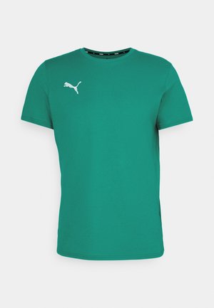 Zelena kratka majica s kratkimi rokavi iz bombaža, okroglega izreza in z belim logotipom Puma na levi strani prsnega koša. Gladka tekstura in standardna prileganje.