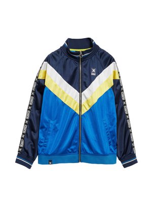 Giacca a zip blu e blu navy con strisce a zigzag gialle, bianche e blu. Presenta nastro con logo bianco e nero lungo le maniche e le tasche laterali.