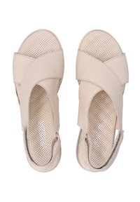 Beige sandals made of leather featuring a cross-strap design, perforated footbed, and cut-out sides. Smooth finish with subtle accents.