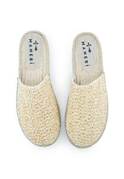 Gelbe gewebte Stoffschlüpfschuhe mit einer strukturierten Oberseite und einer beigen kontrastierenden Innensohle, die ein Logo auf der Innensohle aufgedruckt hat.
