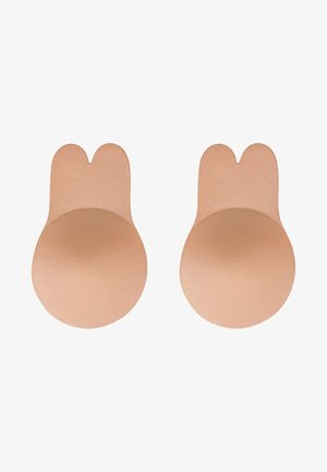 Ihonväriset liimakupit, joissa on pyöreä muoto ja pieni leikkaus ylhäällä. Niissä on sileä pinta, joka mahdollistaa saumattoman kiinnityksen.