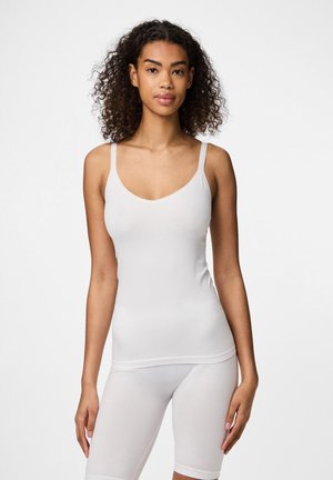White sleeveless top with a deep V-neck, made from smooth, stretchy material. Features thin straps and a fitted design.