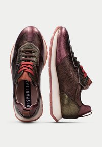 Multicolored sneakers featuring a mix of textured burgundy and green leather, red laces, and a light rubber sole. Accented with a logo at the back.