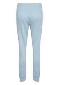 Lysblå sweatpants lavet af blødt stof, med en tapered design, elastisk talje og tætsiddende manchetter ved anklerne.