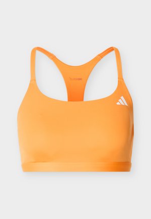Lys orange racerback-sportsbh med tynde stropper, Adidas-logo foran og "Climacool" mærkat på bagpanelet.