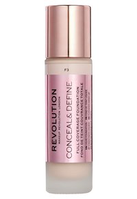 Flacon de fond de teint avec une base en verre dépoli et un capuchon métallique rose. Présente un texte noir en gras. Contient 30 ml de formule liquide.