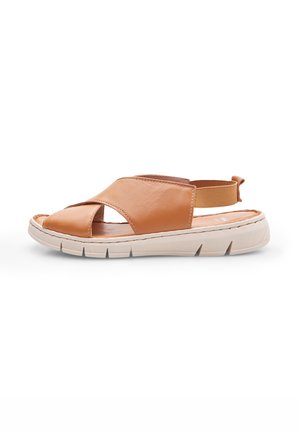 Brown leather sandal with an open-toe design, elastic heel strap, and a textured white sole featuring deep grooves for traction.