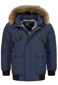 Marineblå puffer-parka med hætte foret med pels. Har lynlåse- og knaplukning foran, ribbede manchetter og en skinnende inderside.