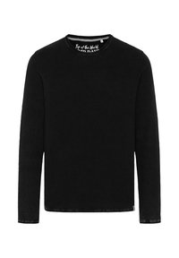 Black long-sleeve shirt with a textured knit pattern, round neckline, and a straight cut. Features a tag inside with branding.