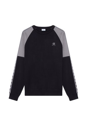 Zwarte trui met grijze raglanmouwen, ribgebreide manchetten en tailleband. Heeft een klein logo op de borst en patroon details langs de mouwen.