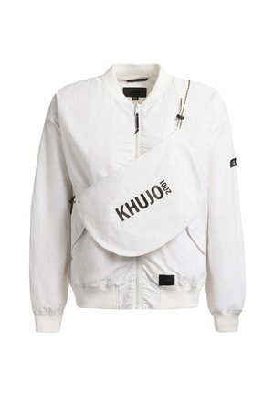 White bomber jacket with front zipper and large white crossbody bag labeled "KHUJO 2001" across the chest.
