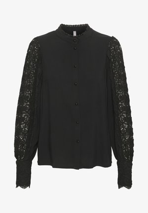 Blusa nera con maniche lunghe in pizzo con motivi floreali, chiusura con bottoni e colletto rotondo con finiture decorative. Tessuto morbido.