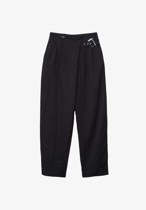 Musta korkeavyötäröinen kapenevat housut, joissa on laskokset ja koristeellinen hopeinen solki vyötärönauhan oikealla puolella.