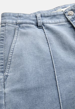 Light blue denim jeans with front pockets, belt loops, and a metal button closure at the waistband.