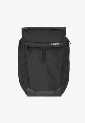 Le sac à dos Thule noir présente un tissu texturé, des fermetures éclair, un rabat supérieur et une base renforcée. Conception compacte avec des bretelles rembourrées.