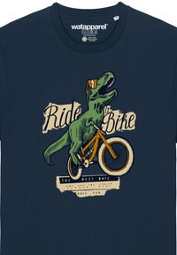 Marineblauwe katoenen T-shirt met een grafische afbeelding van een groene dinosaurus die op een oranje fiets rijdt, met dikke tekst: "Fiets" en "De Beste Dagen."