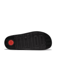 Zwarte rubberen schoenzool met een textuur voor grip, voorzien van verhoogde "fitflop" branding en een circulair rood logo met golfpatroon.