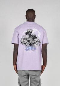 Light purple cotton t-shirt featuring a graphic print on the back of two figures, surrounded by a blue and white abstract design.